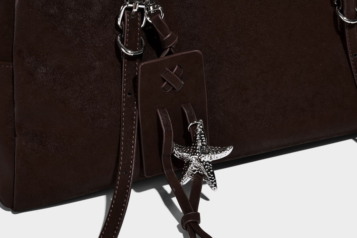 Structured rectangular matte suede-like shoulder bag with silver-tone hardware, zip closure, double top handles, and, detail