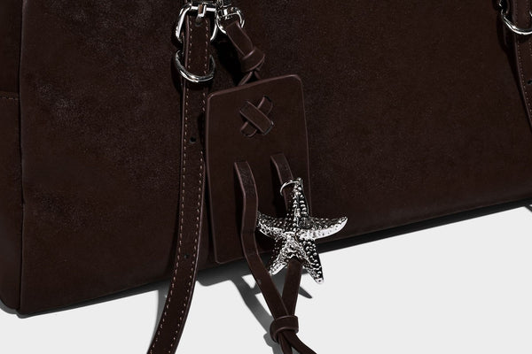 Structured rectangular matte suede-like shoulder bag with silver-tone hardware, zip closure, double top handles, and, detail