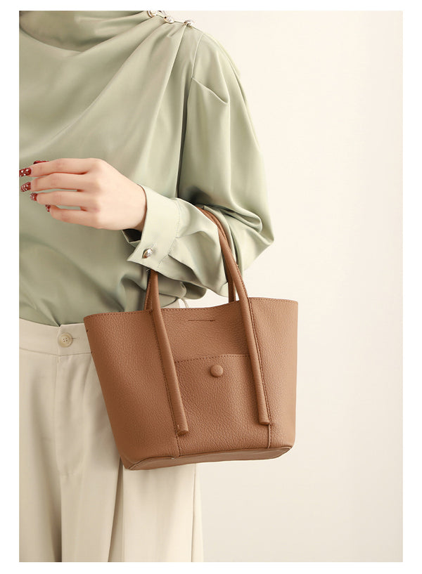 Structured pebbled matte tote bag with front snap pocket, dual top handles, and detachable zip pouch in almond beige, detail