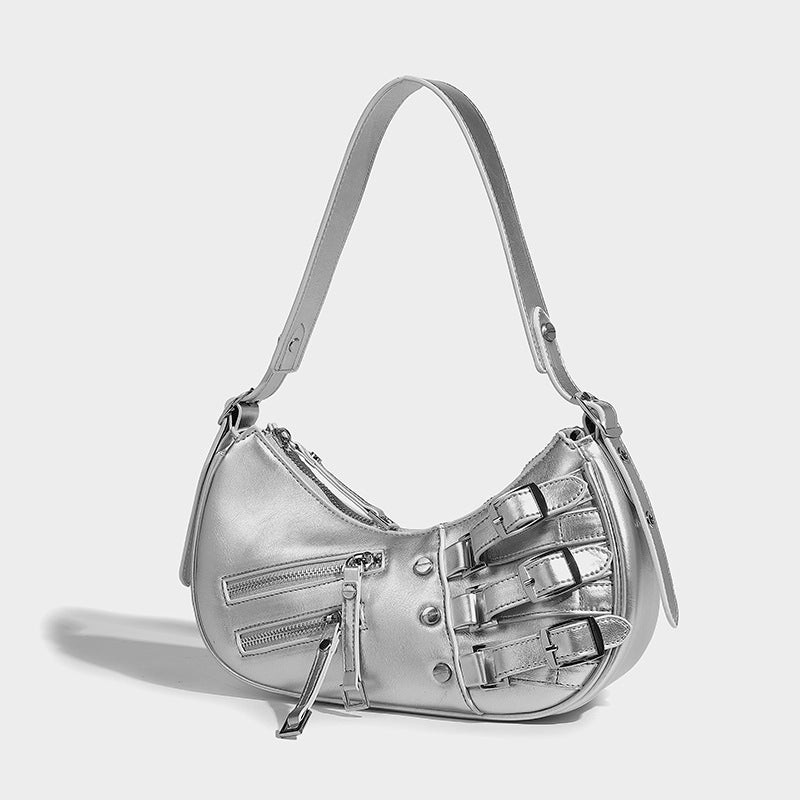 Crescent shoulder bag in washed blue denim-look PU with stacked buckle straps, front zip pocket, and silver-tone hardware