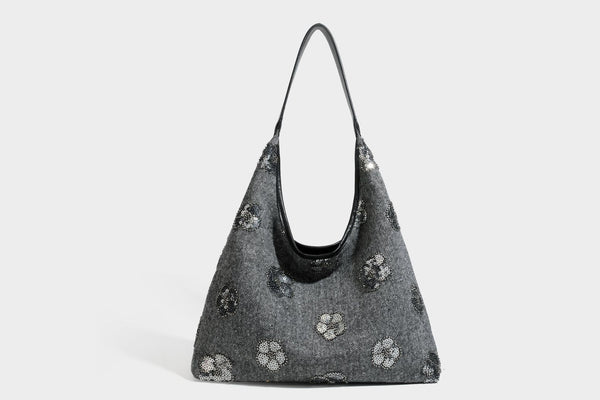 Lässig fallende, trapezförmige Schulter-Tote in Anthrazitgrau mit floralen Paillettenmotiven in Silber, Riemen in Lederoptik und herabhängendem Perlenbesatz