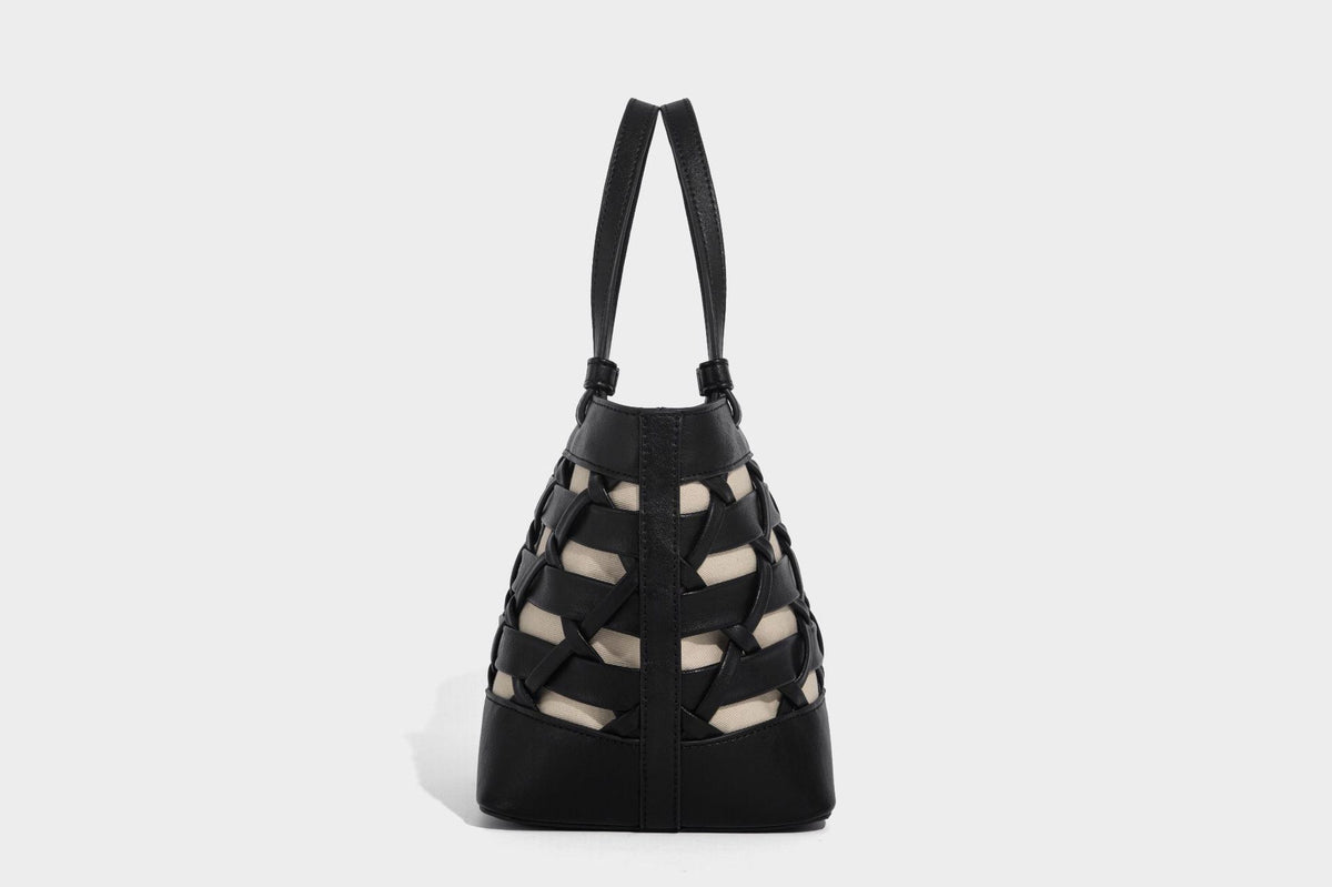 Structured woven lattice tote bag with cream lining, dual top handles, detachable crossbody strap, and silver-tone hardware