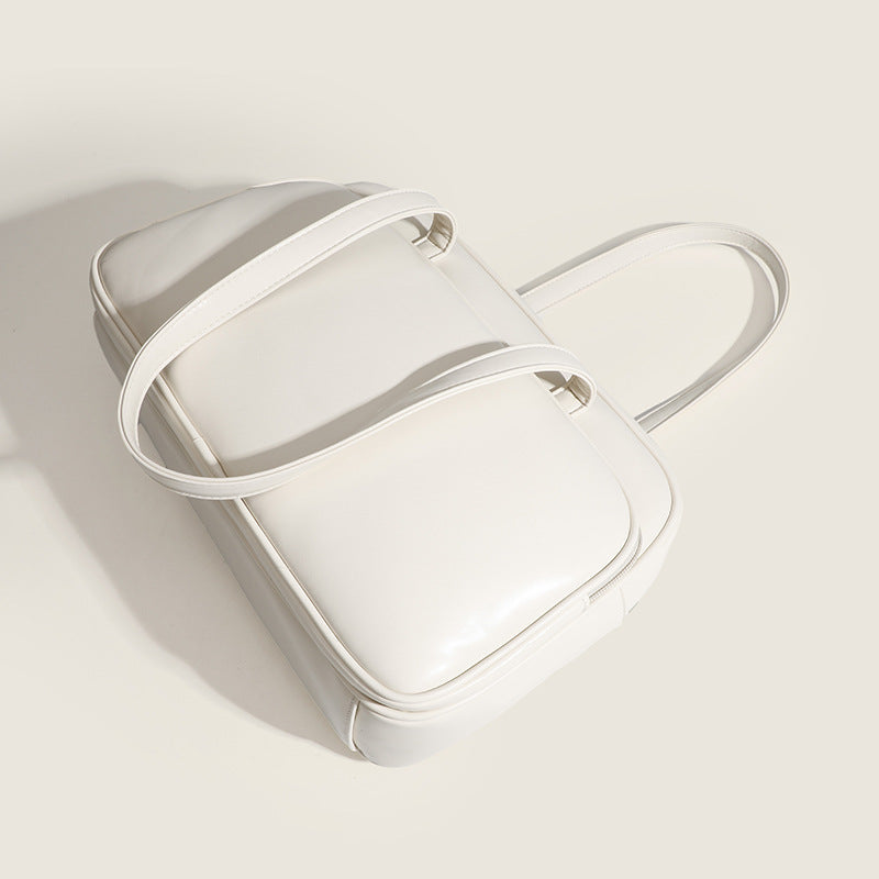 Large structured rectangular leather-look shoulder bag with dual zip compartments and double top handles, detail view 4