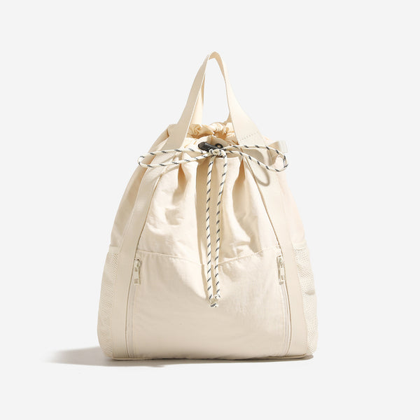 Soft matte drawstring backpack tote with braided cord closure, front zip pocket, and mesh side panels, detail view 6