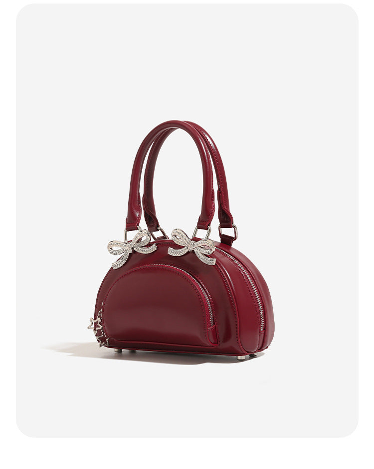 Structured half-moon mini handbag with silver-tone crystal bow hardware and star charm chain, detail view 8