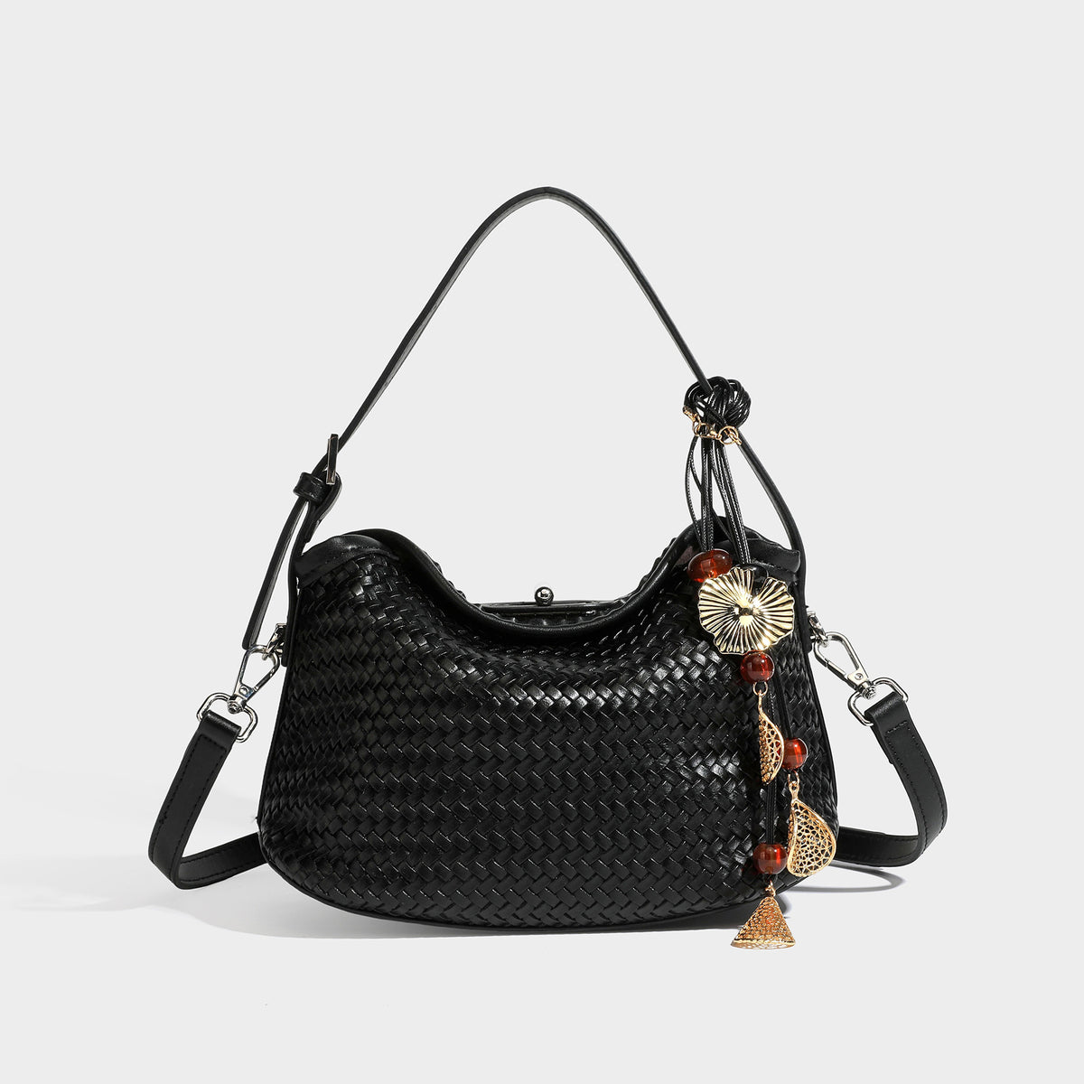 Small woven-look leather-look flap shoulder hobo bag in burgundy with silver-tone hardware and decorative tassel charm