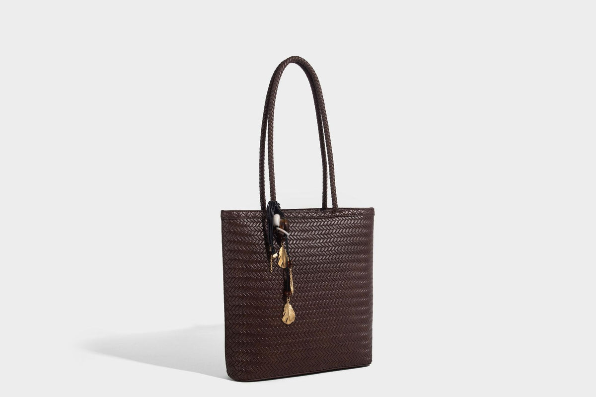 Structured woven herringbone tote bag with braided double shoulder handles in tan brown, shown with matching drawstring