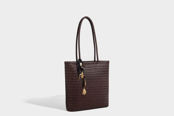 Structured woven herringbone tote bag with braided double shoulder handles in tan brown, shown with matching drawstring