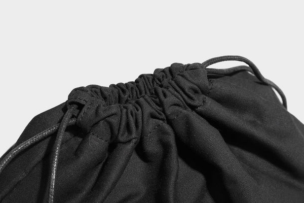 Slouchy brown leopard jacquard hobo tote bag with black leather-look trim and single shoulder strap, shown with black, detail