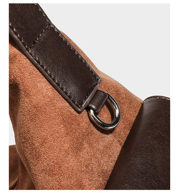 Cognac brown suede-look slouchy shoulder bag with dark brown leather-look trim, top zip closure, exterior side pocket, and