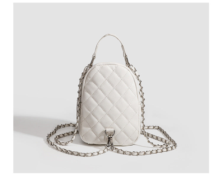 Compact diamond-quilted mini backpack handbag with silver-tone chain straps and turn-lock front pocket, detail view 15