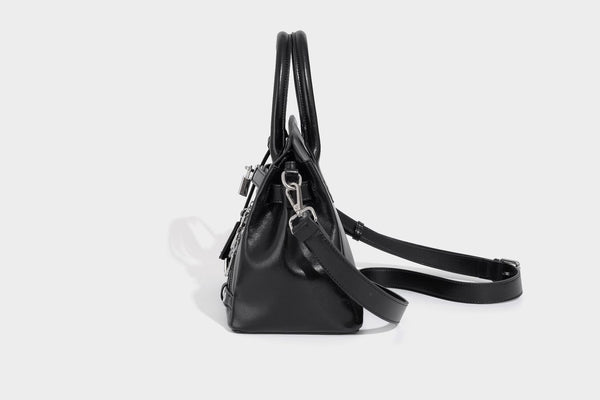 Structured black leather-look satchel bag with silver padlock hardware, front zip pockets, key charms, and top handles