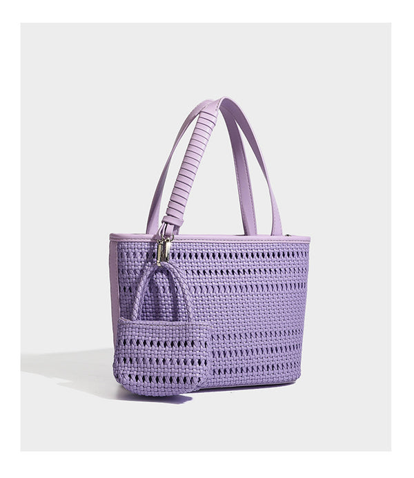 Structured open-weave tote bag with smooth leather-look trim, double top handles, detachable crossbody strap, and mini zip