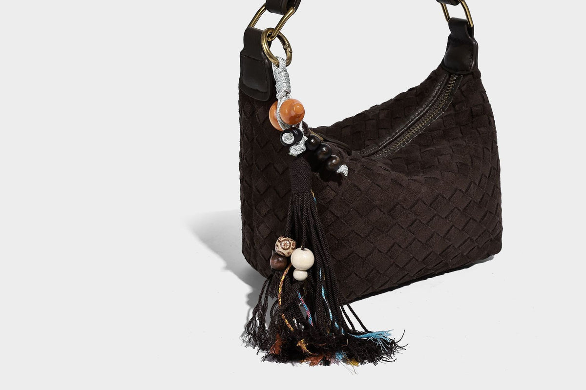 Small woven-texture crescent hobo bag in dark chocolate brown with top zip closure, gold-tone hardware, and adjustable