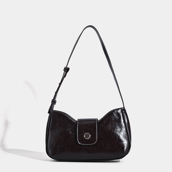 Compact glossy leather-look shoulder bag with round metal snap closure and contrast stitching, front view