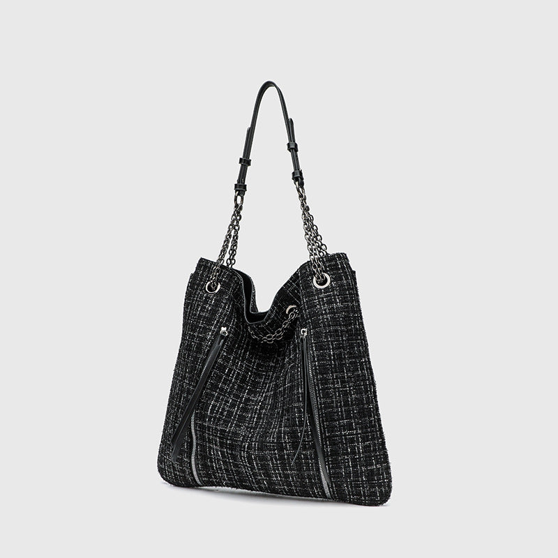 Large black tweed-texture shoulder tote bag with silver-tone chain and leather-look straps, metal eyelets, and exterior zip