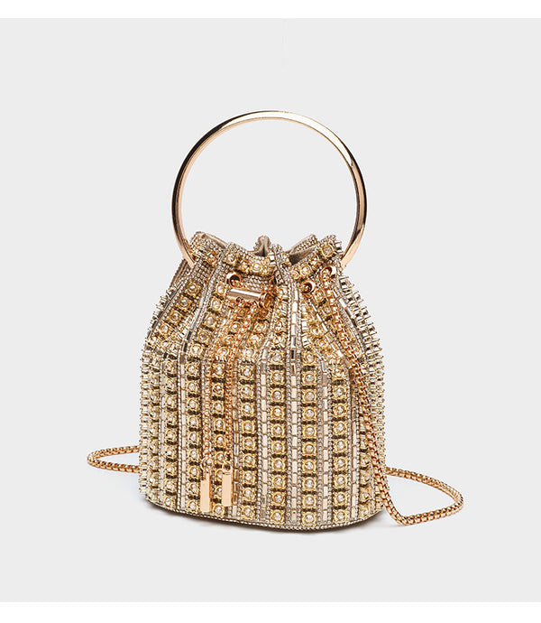 Mini crystal rhinestone bucket bag with circular ring top handle, drawstring closure, and silver chain shoulder strap, detail