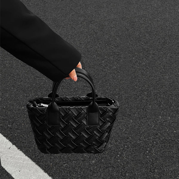 Small black glossy woven tote bag with dual top handles and detachable shoulder strap, detail view 3