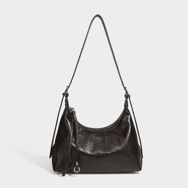 Slouchy hobo shoulder bag in glossy crinkled leather-look finish with zip-top closure and silver-tone ring hardware, detail