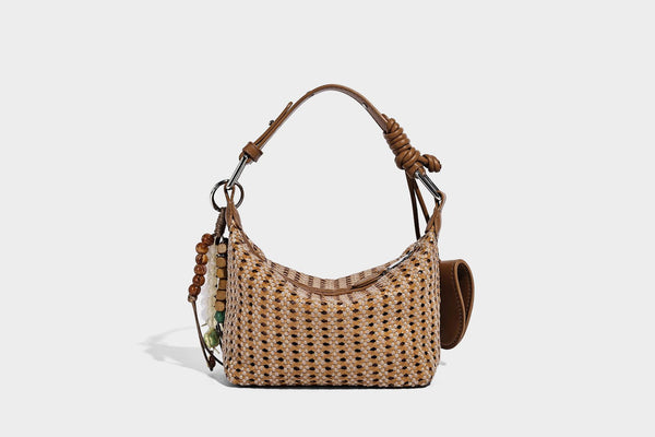 Woven crescent shoulder bag with leather-look knotted handle, zip top, attached mini pouch, and silver-tone hardware, detail