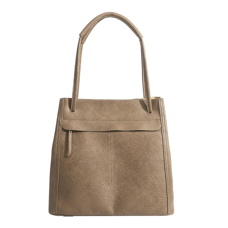Retro structured matte leather-look tote bag in camel with front flap pocket, tassel pull, and double top handles, detail