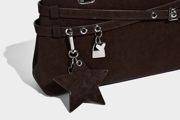 Structured trapezoid shoulder tote in dark brown matte suede-look finish with dual straps, wraparound belt bands