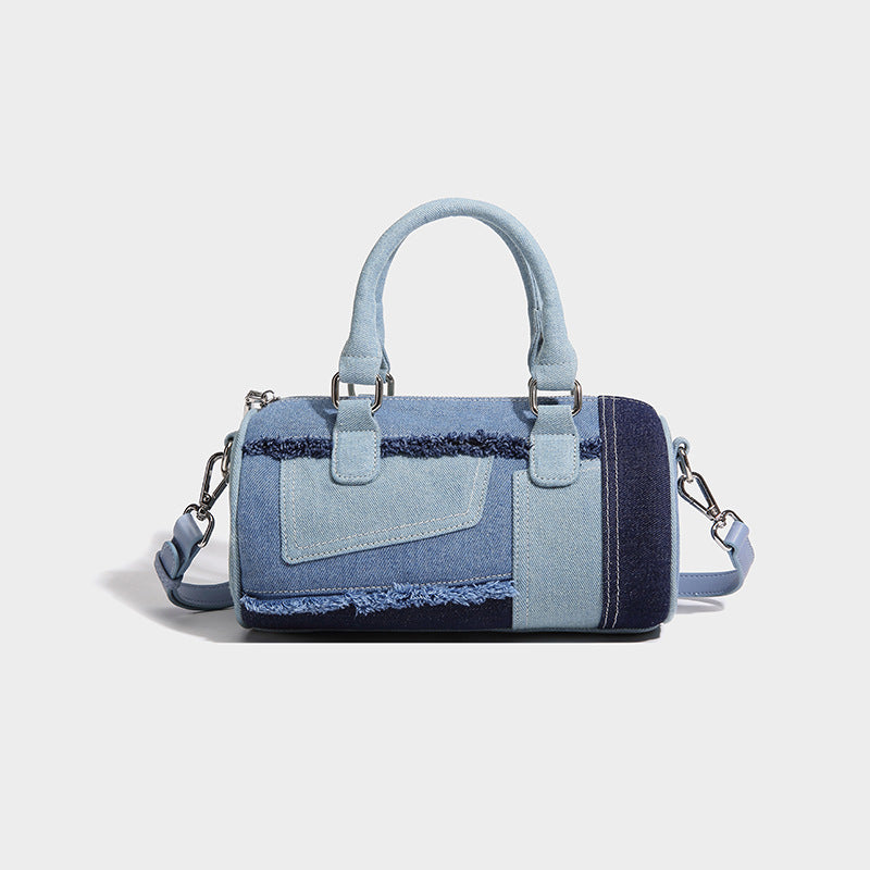 Mini barrel handbag in light and dark denim patchwork with frayed seam trim, dual top handles, top zip closure, and, detail