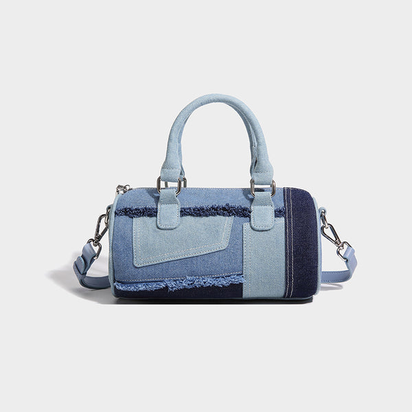 Mini barrel handbag in light and dark denim patchwork with frayed seam trim, dual top handles, top zip closure, and, detail