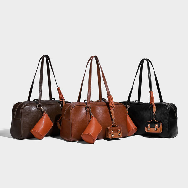 Strukturierte Boston-Schultertasche in glänzender Lederoptik mit zwei langen Trageriemen, Reißverschluss oben, goldfarbenen Metalldetails und zwei