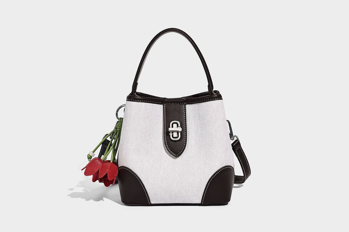 Small structured bucket bag in denim-look light blue fabric with black leather-look trim, silver turn-lock hardware, short