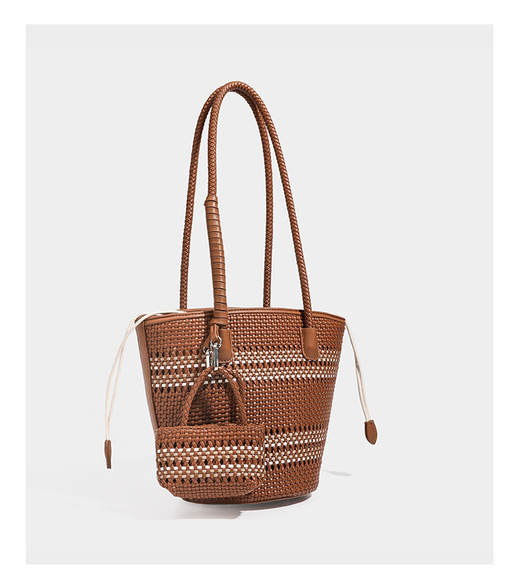 Structured woven bucket tote bag in pastel blue with braided shoulder strap, open lattice weave body, cream drawstring