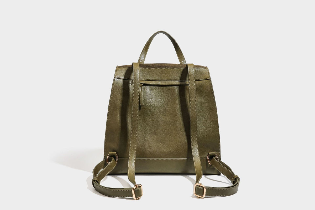 Structured suede-look convertible backpack handbag with flap closure and gold-tone emblem hardware in chocolate brown, detail