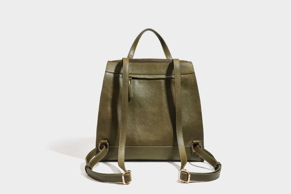 Structured suede-look convertible backpack handbag with flap closure and gold-tone emblem hardware in chocolate brown, detail