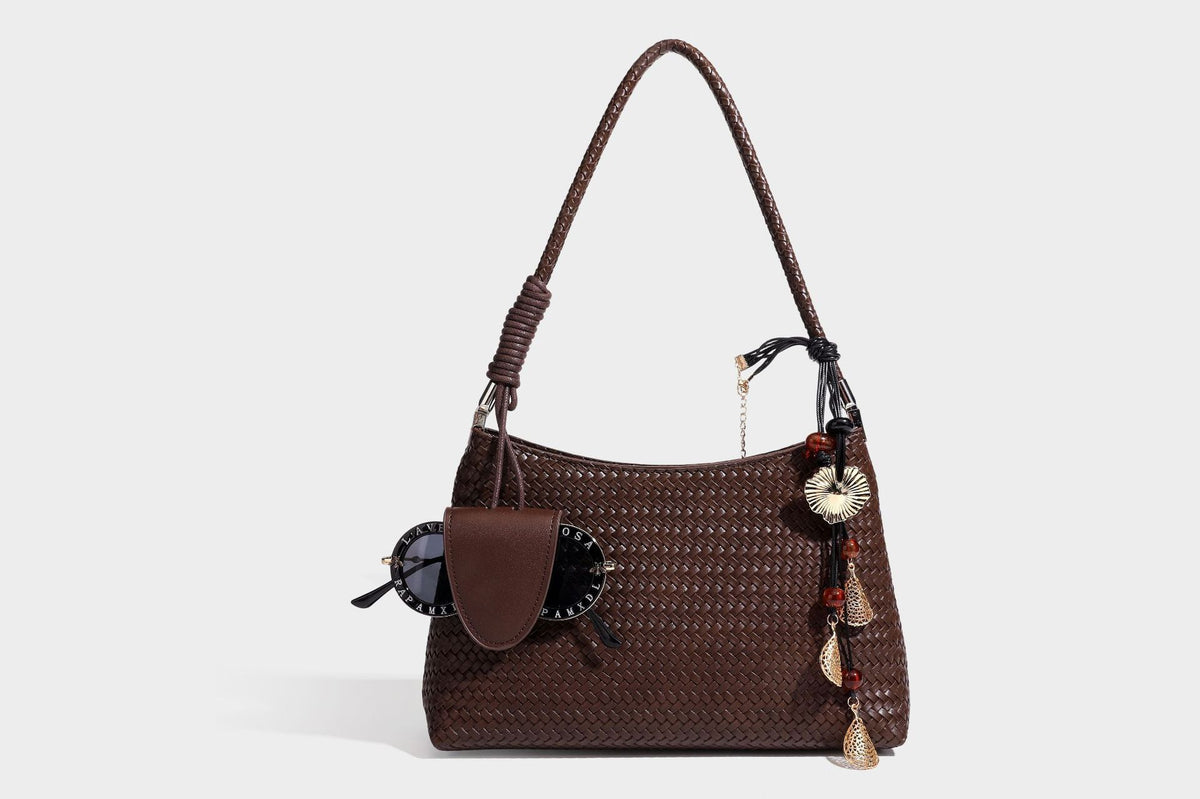 Woven-texture hobo shoulder bag in brown with braided top handle, adjustable crossbody strap, front flap pocket, and, detail