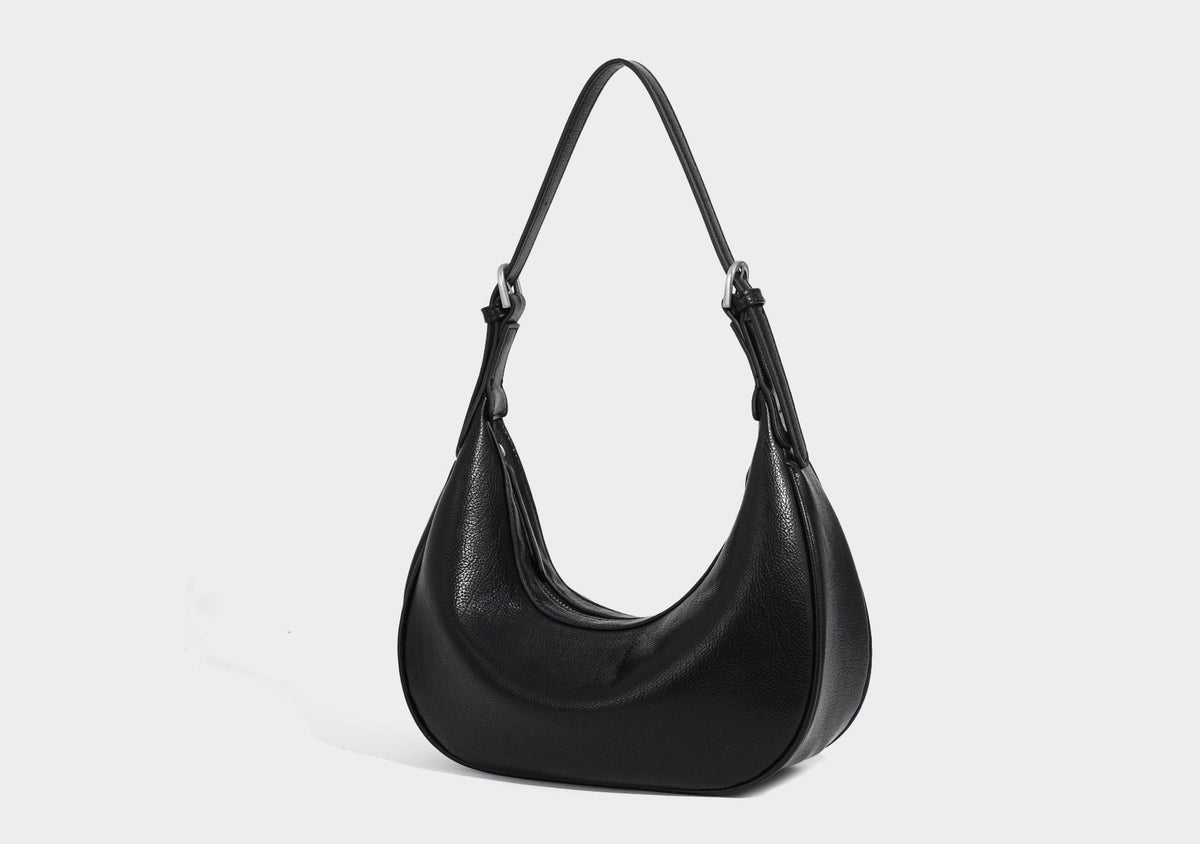 Crescent half-moon shoulder bag in pebbled leather-look finish with adjustable strap and silver-tone hardware, detail view 19