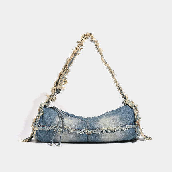 Large slouchy washed denim shoulder bag with frayed raw-edge trim and zip-top closure, detail view 7
