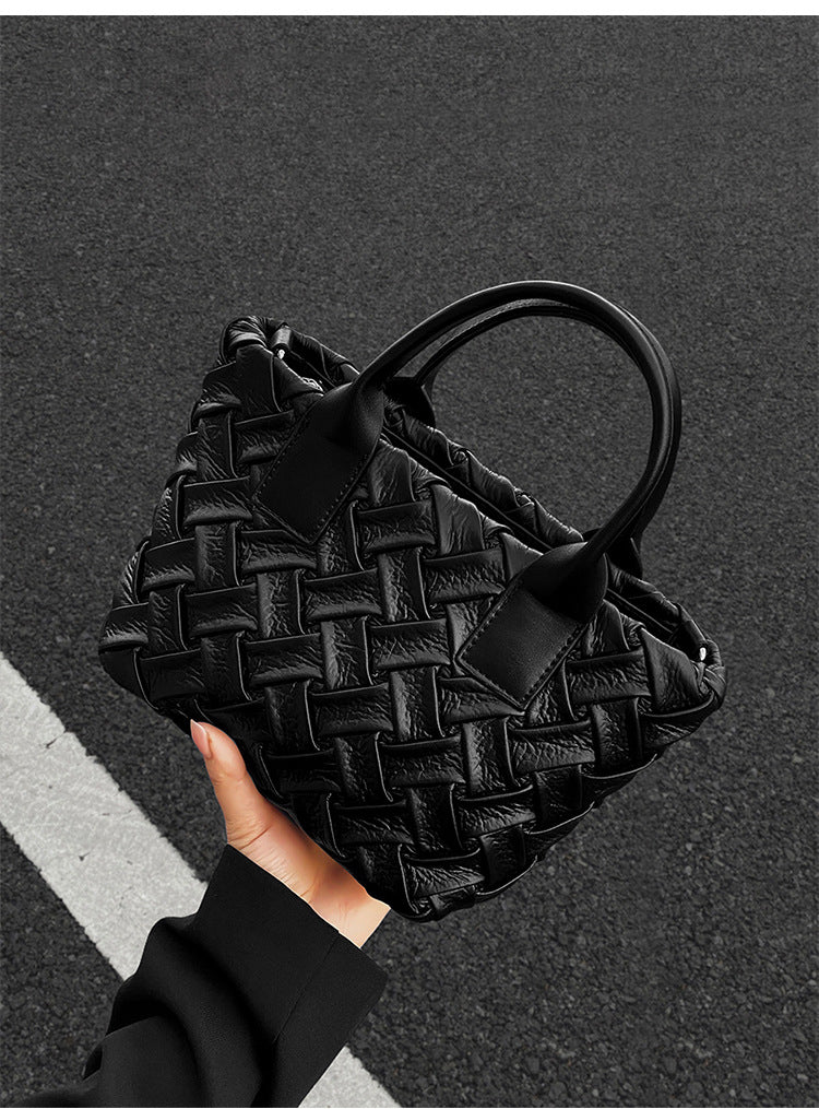 Small black glossy woven tote bag with dual top handles and detachable shoulder strap, detail view 11