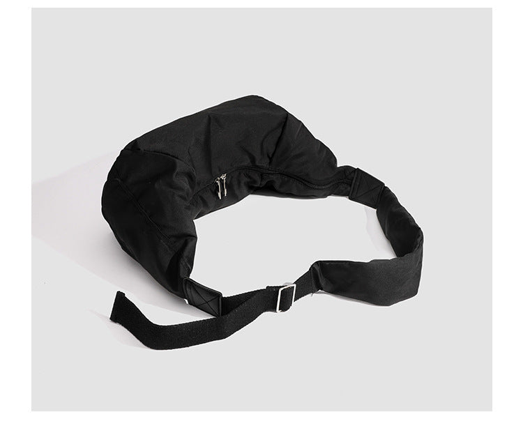 Large crescent sling shoulder bag in gathered fabric with zip closure and adjustable strap, detail view 14