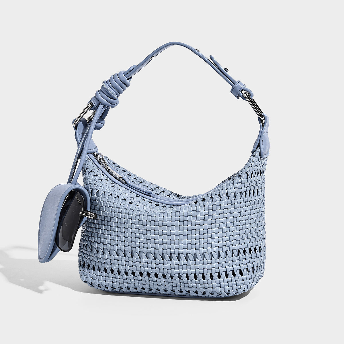 Small woven lattice hobo shoulder bag with crescent silhouette, top zip closure, silver-tone hardware, and adjustable, front