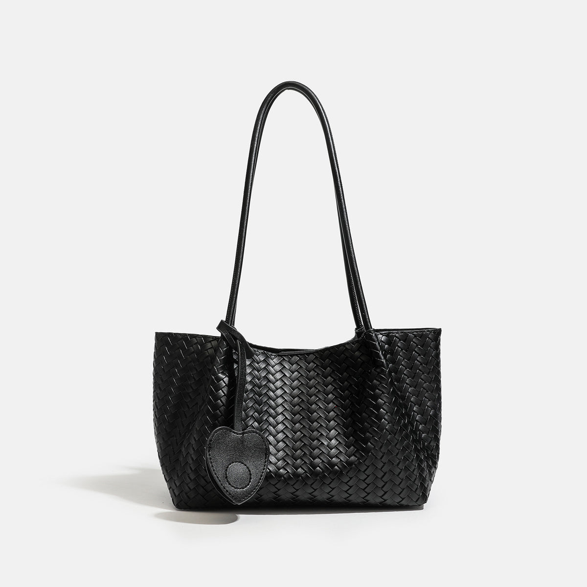 Woven leather-look tote bag in yellow with long shoulder straps, heart-shaped hanging charm, and removable inner zip pouch