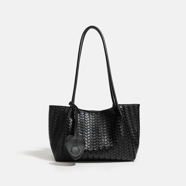Woven leather-look tote bag in yellow with long shoulder straps, heart-shaped hanging charm, and removable inner zip pouch