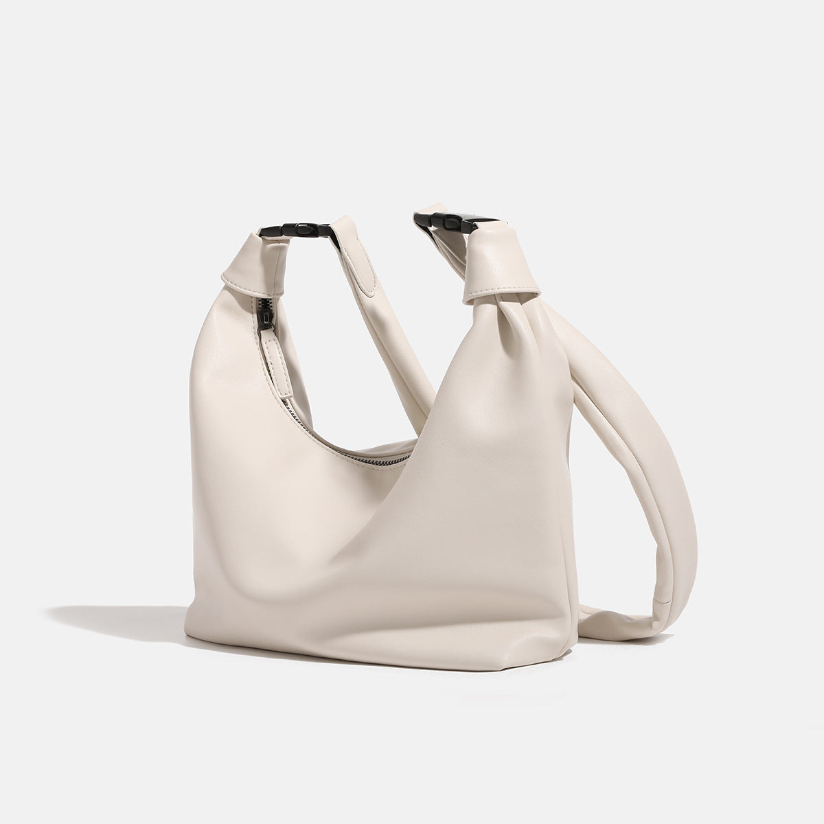 Slouchy leather-look hobo bag with knotted loop handle and top zipper closure, detail view 3