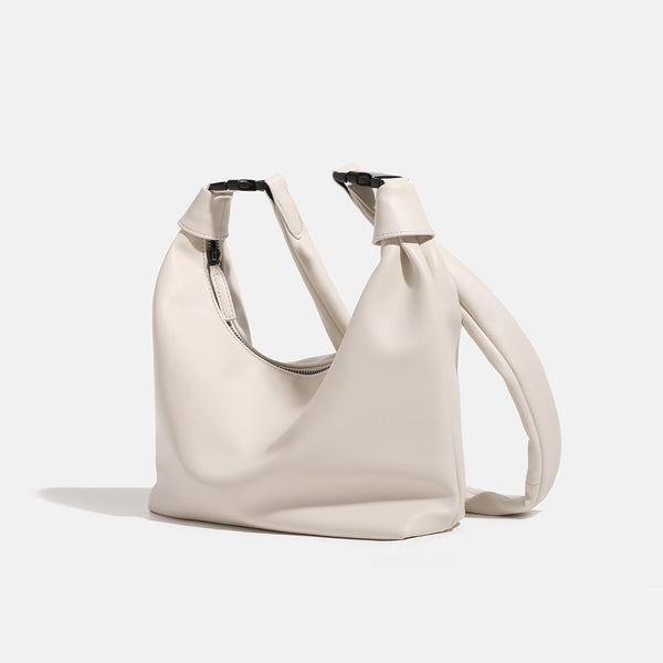 Slouchy leather-look hobo bag with knotted loop handle and top zipper closure, detail view 3