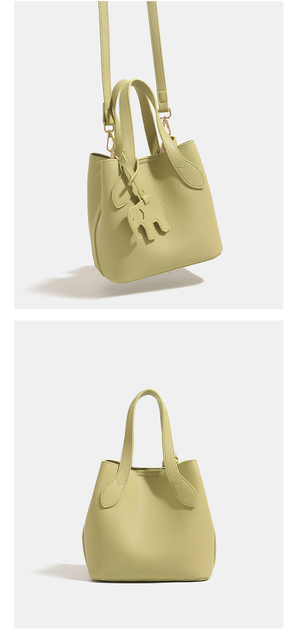 Pebbled leather-look bucket tote with elephant charm pendant, dual top handles, and detachable shoulder strap, detail view 13