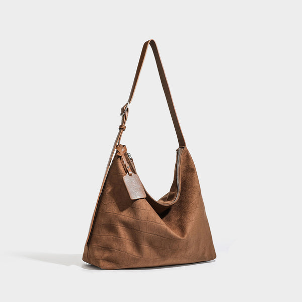 Slouchy hobo shoulder bag in matte croc-embossed leather-look finish with top zip closure and long adjustable strap, front