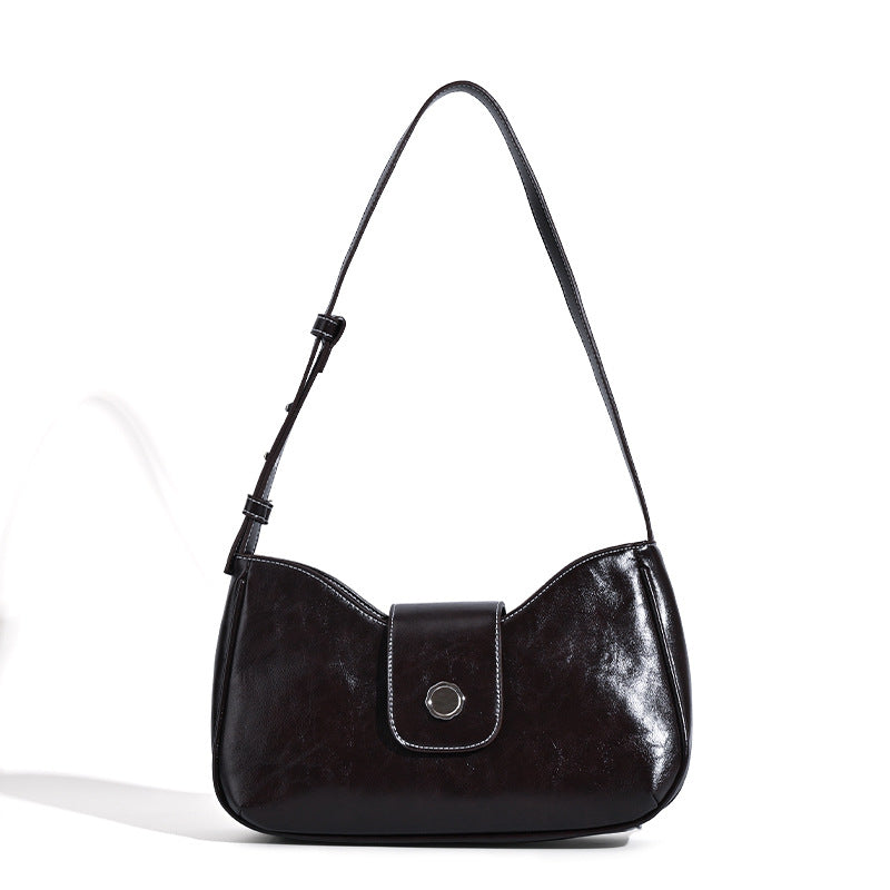 Compact glossy leather-look shoulder bag with round metal snap closure and contrast stitching, detail view 5