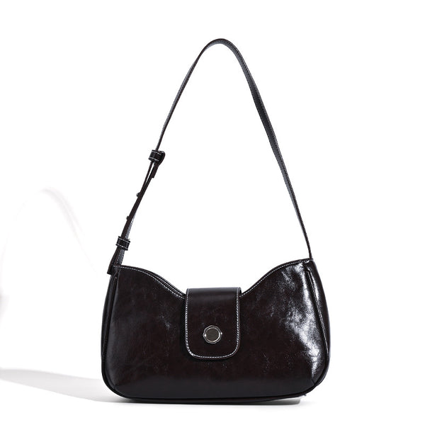 Compact glossy leather-look shoulder bag with round metal snap closure and contrast stitching, detail view 5