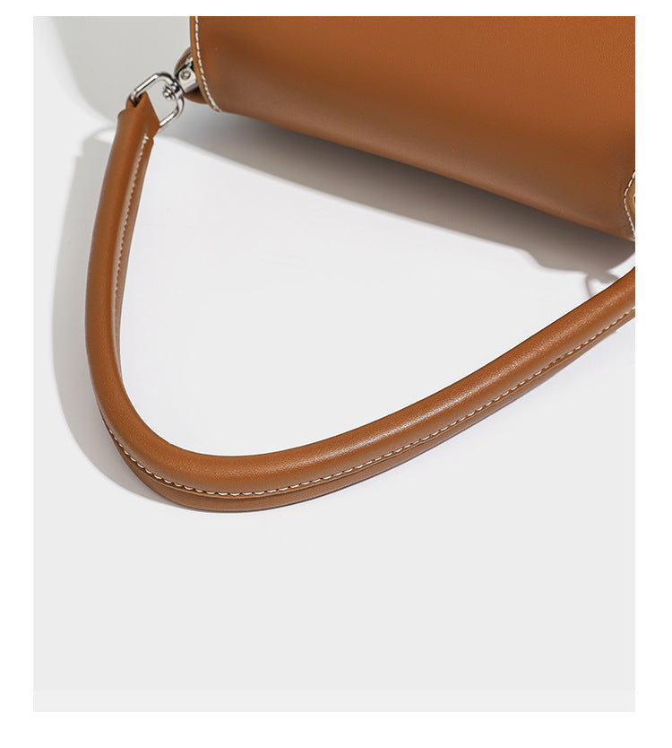 Cream canvas bucket bag with blue horizontal stripes, tan leather-look flap and trim, drawstring closure, silver-tone, detail