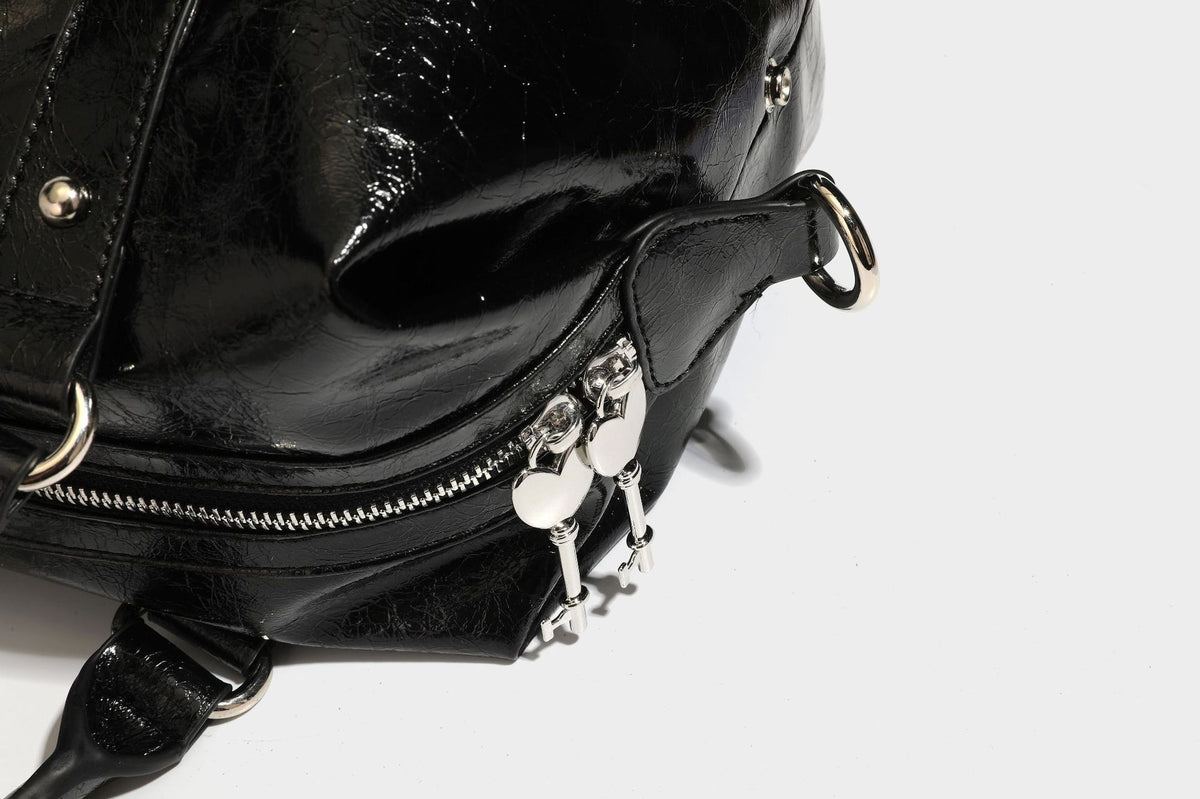 Glossy crinkled barrel handbag with silver stud buckle strap and detachable shoulder strap, detail view 35