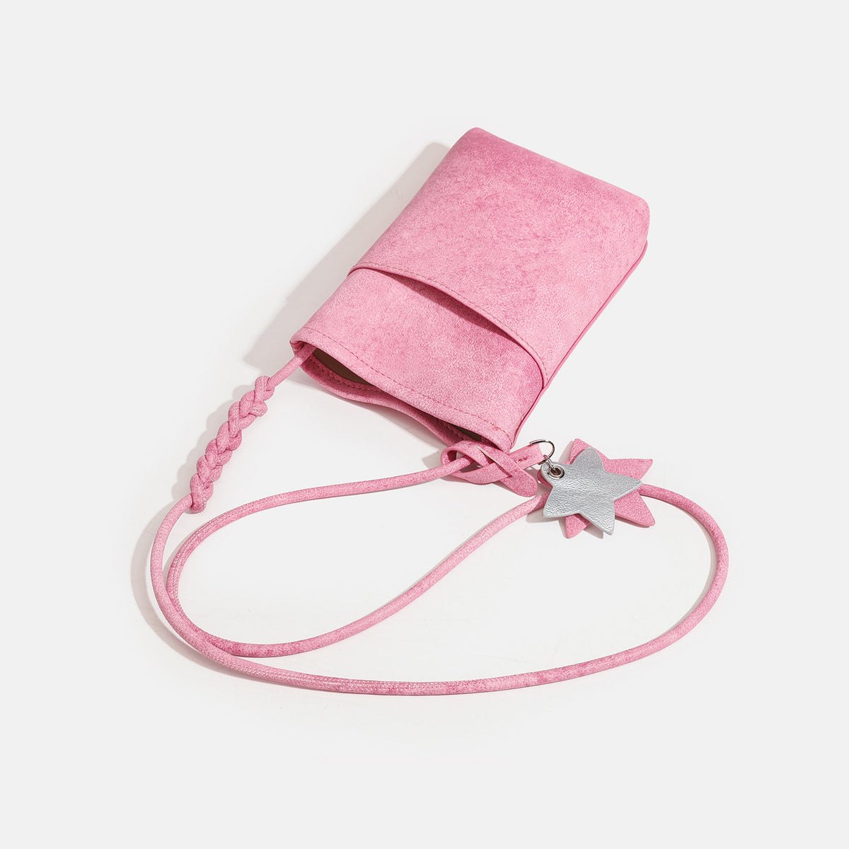 Small vertical textured mini crossbody phone bag with long braided cord strap and silver-toned star charm, detail view 4